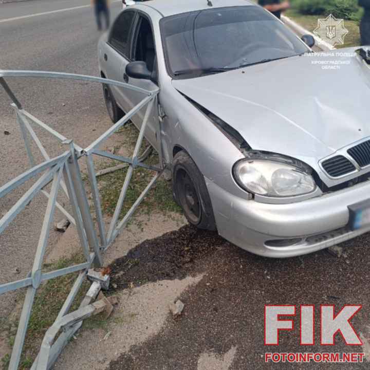 Розбитий Daewoo Lanos біля знесеного дорожнього паркана на вулиці Вокзальній у Кропивницькому, оформлення ДТП патрульними.