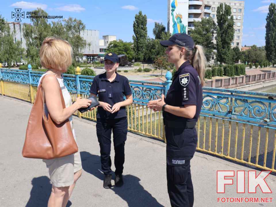 Офіцерка-рятувальниця ДСНС та патрульна поліцейська проводять роз'яснювальну роботу про правила безпеки на воді з жителями Кропивницького біля річки Інгул.